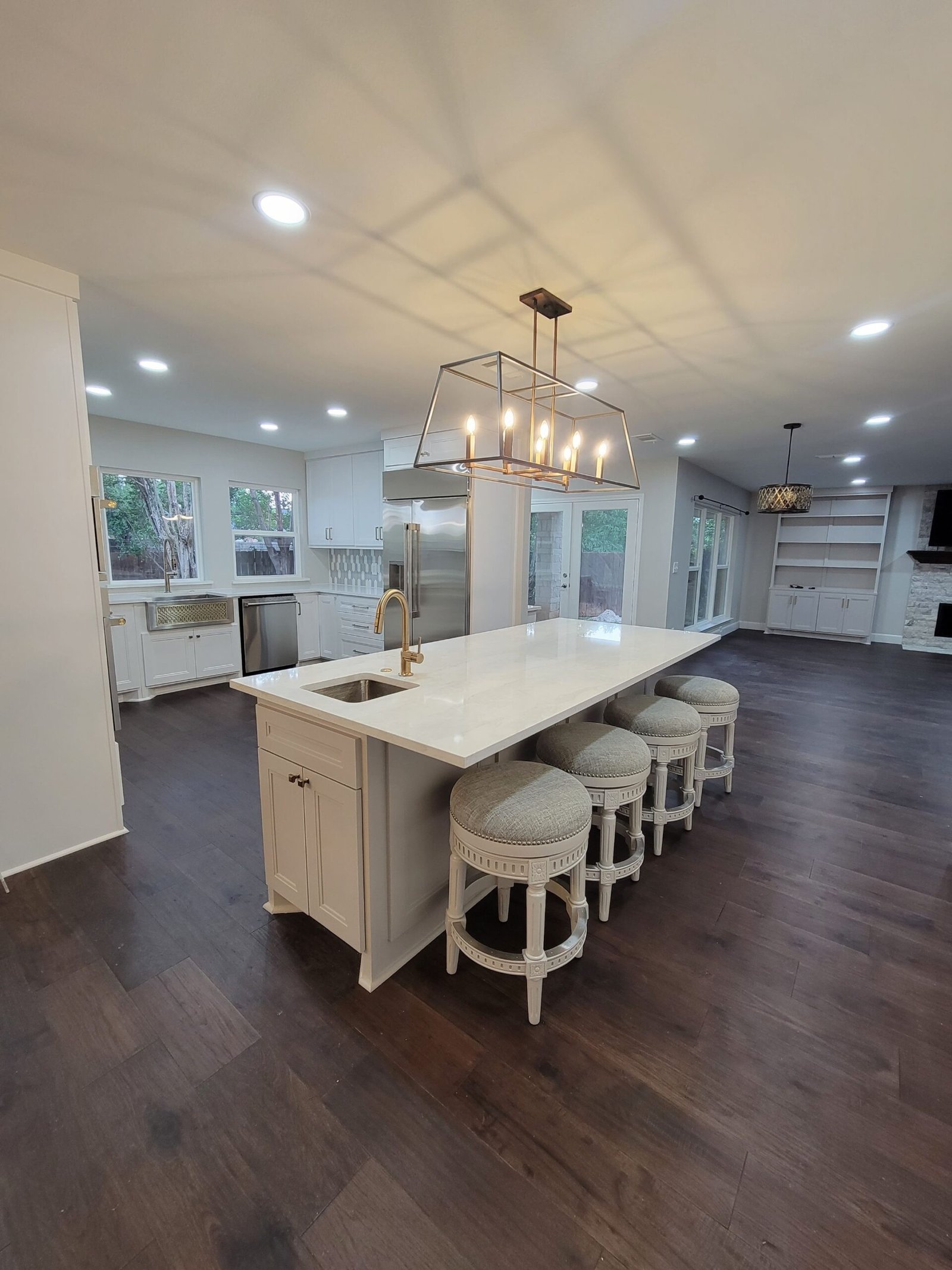 Modern Kitchen remodel with white marble countertop installation and white veneered cabinetry refinishing in Frisco TX.